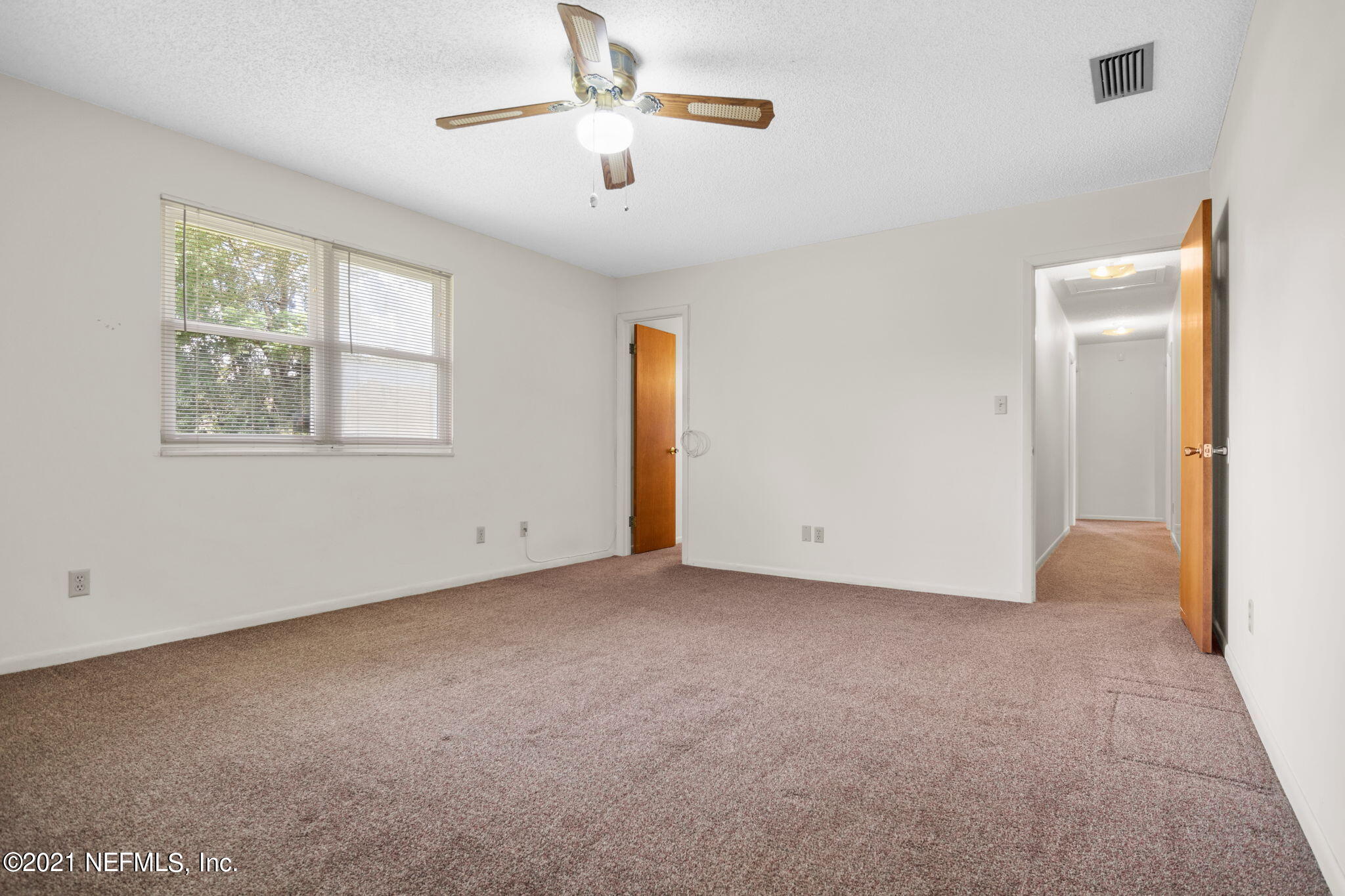 4730 Ricker Road Jacksonville, FL 32210 - Photo 16 of 30 an empty room with windows and fan