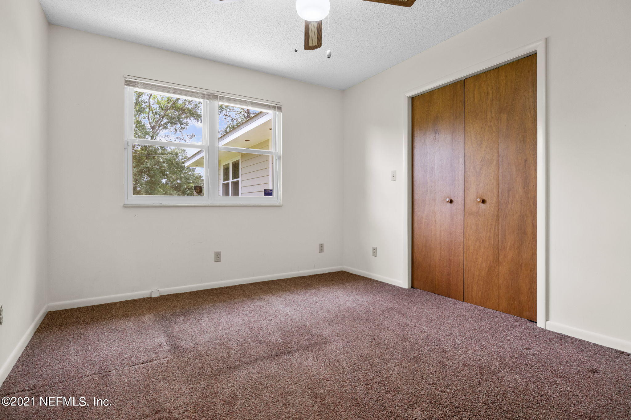 4730 Ricker Road Jacksonville, FL 32210 - Photo 20 of 30 an empty room with windows and closet