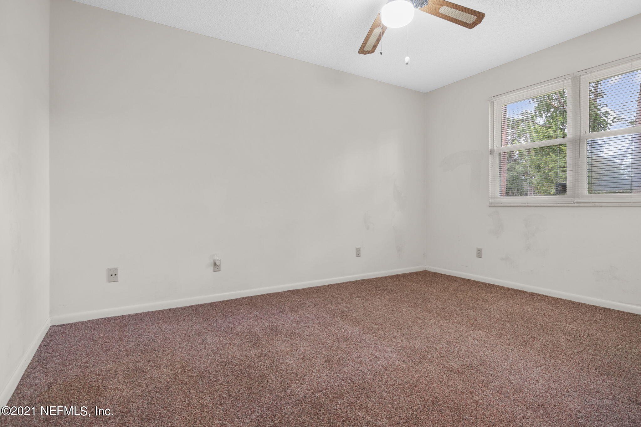 4730 Ricker Road Jacksonville, FL 32210 - Photo 22 of 30 an empty room with windows