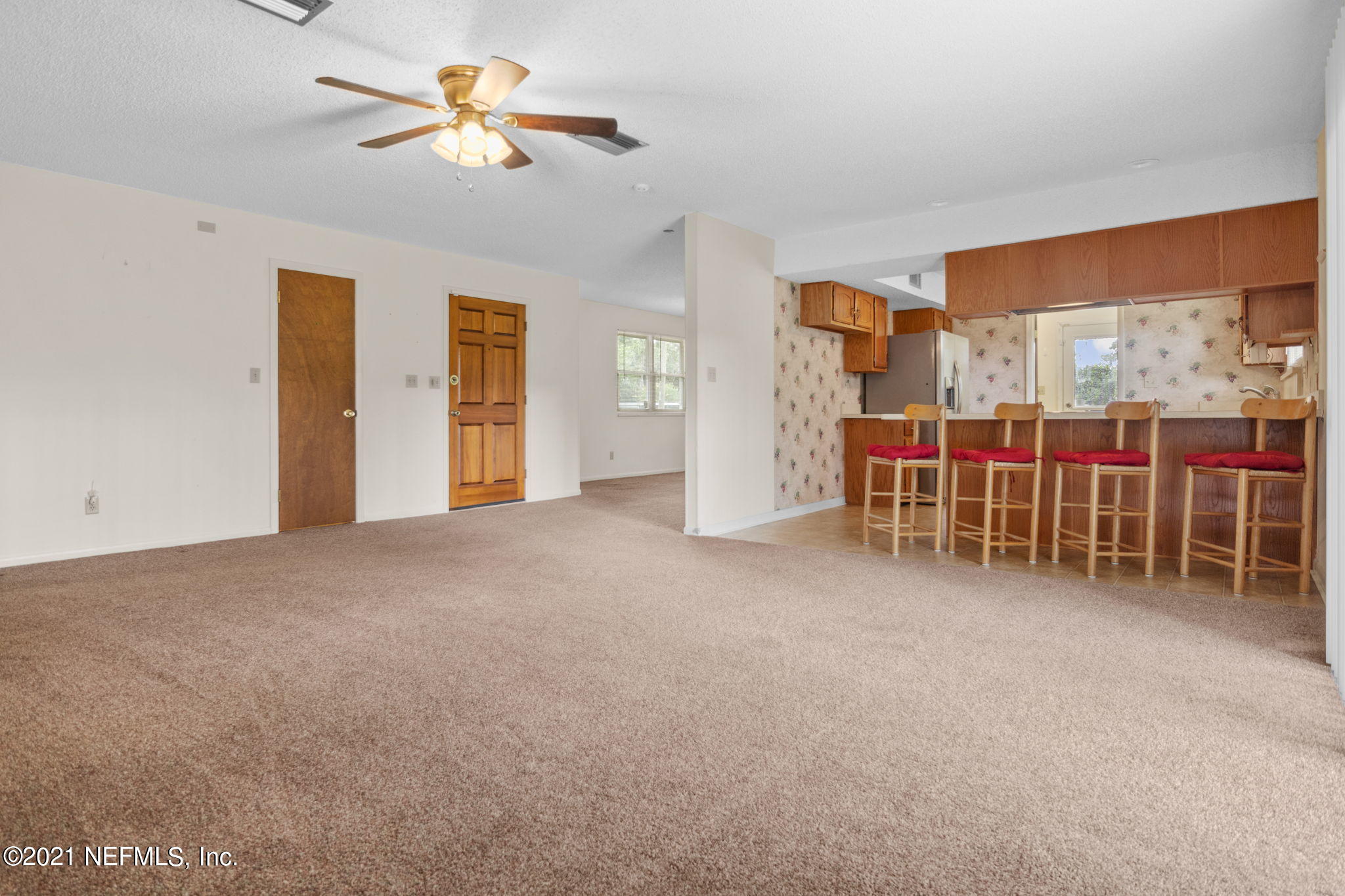 4730 Ricker Road Jacksonville, FL 32210 - Photo 25 of 30 a view of a livingroom with furniture and a ceiling fan