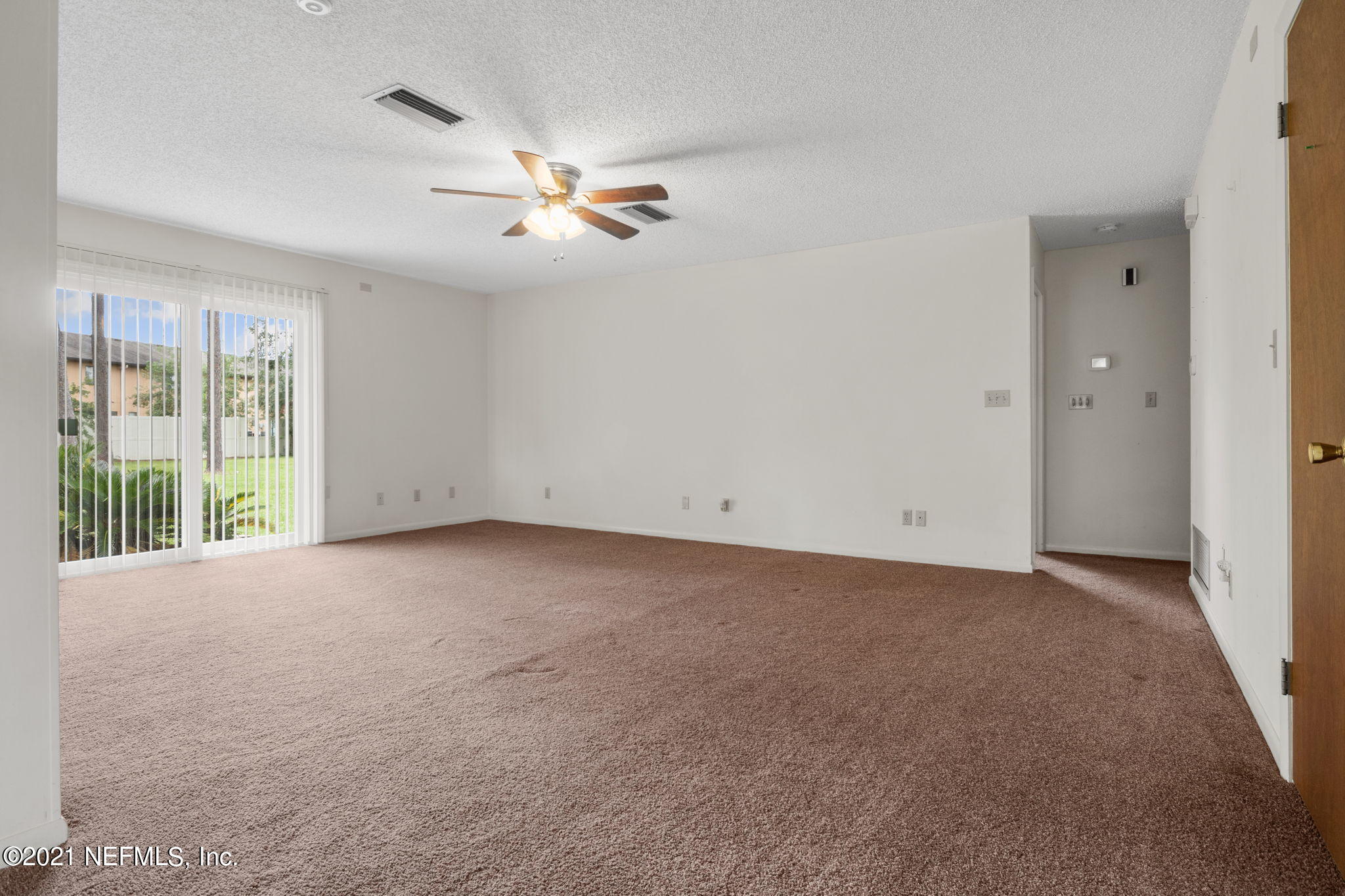 4730 Ricker Road Jacksonville, FL 32210 - Photo 26 of 30 a view of a livingroom with a ceiling fan and window