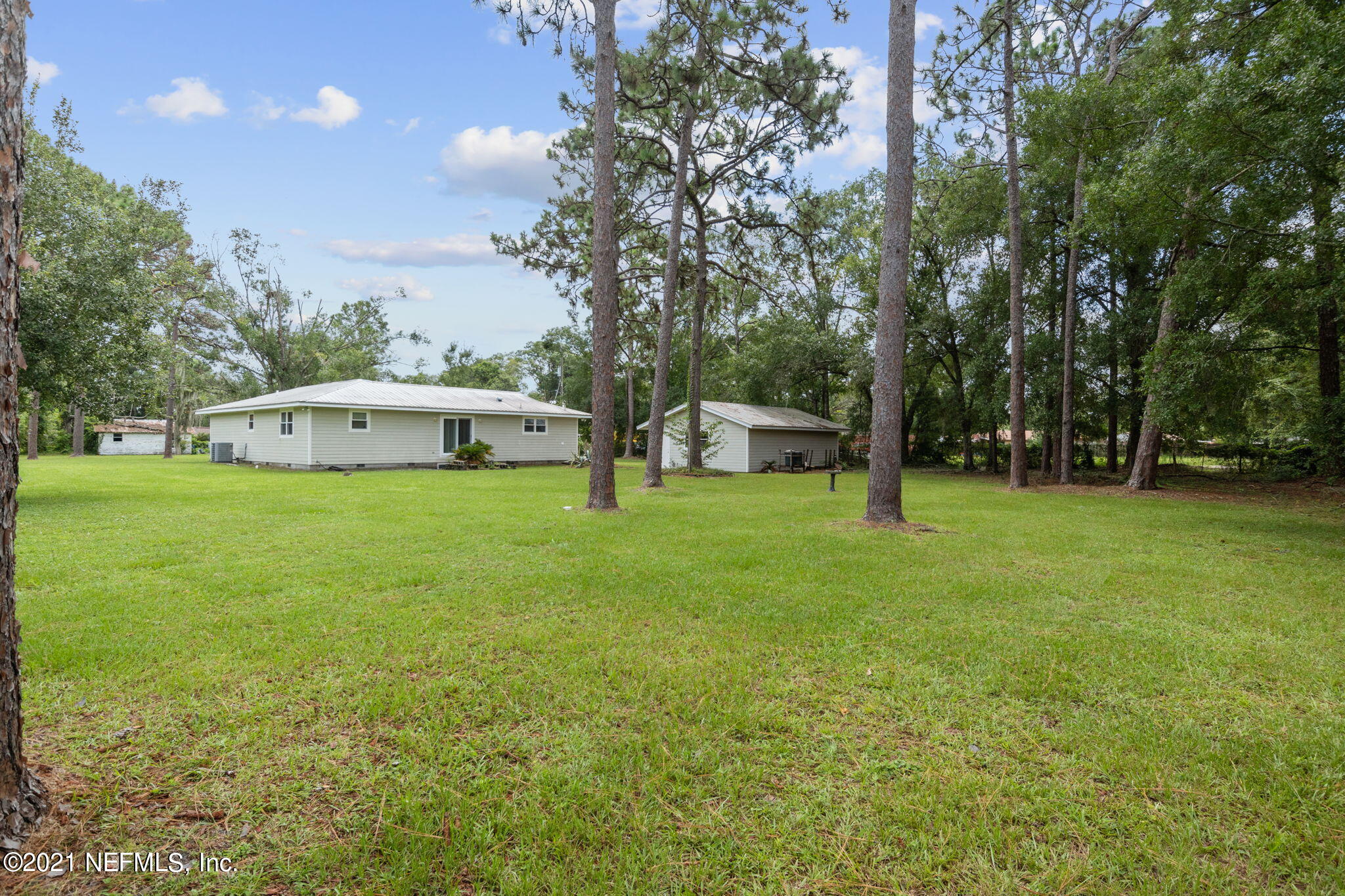 4730 Ricker Road Jacksonville, FL 32210 - Photo 3 of 30 a view of a house with a yard and sitting area