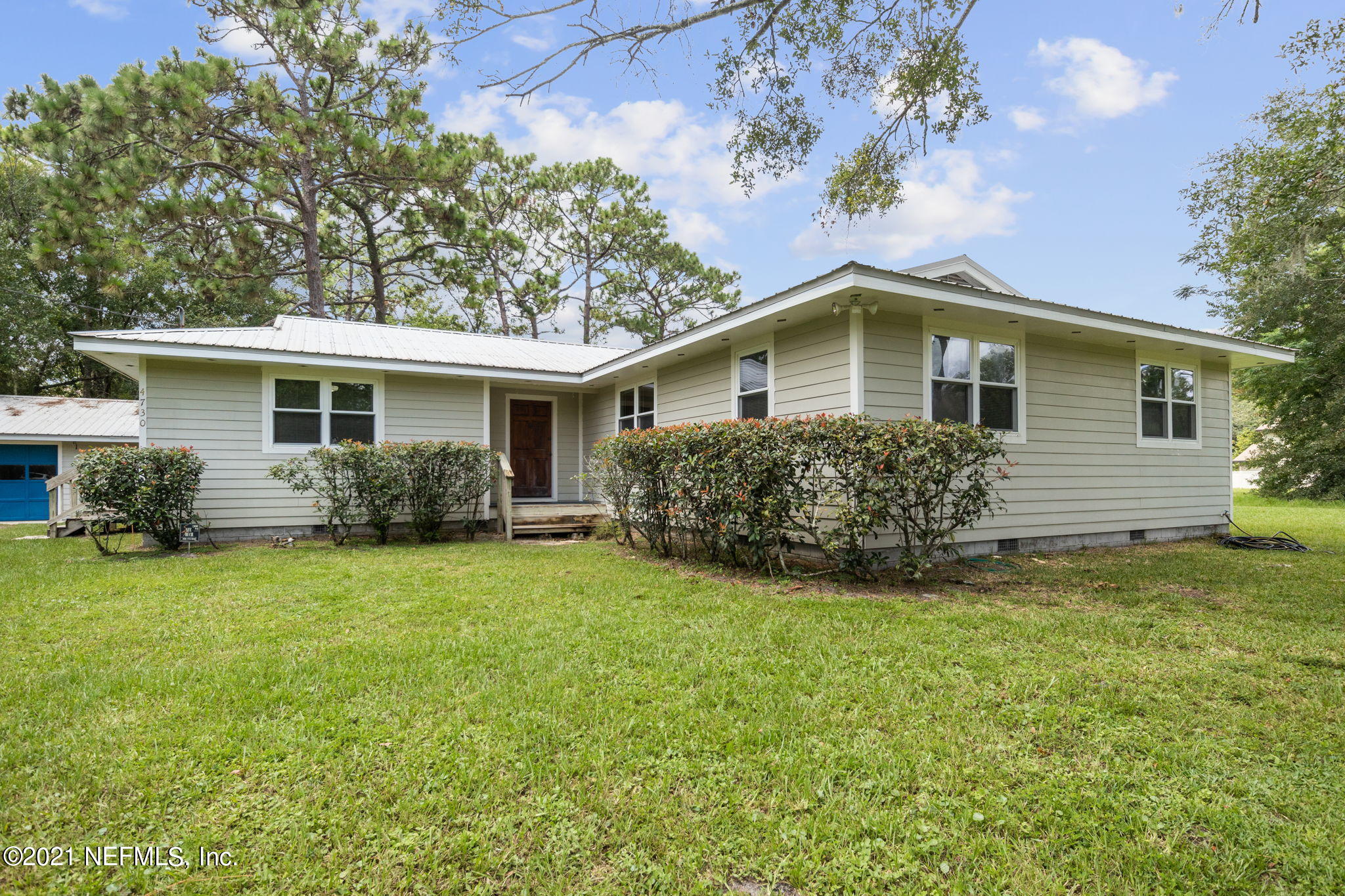 4730 Ricker Road Jacksonville, FL 32210 - Photo 4 of 30 a front view of a house with a garden