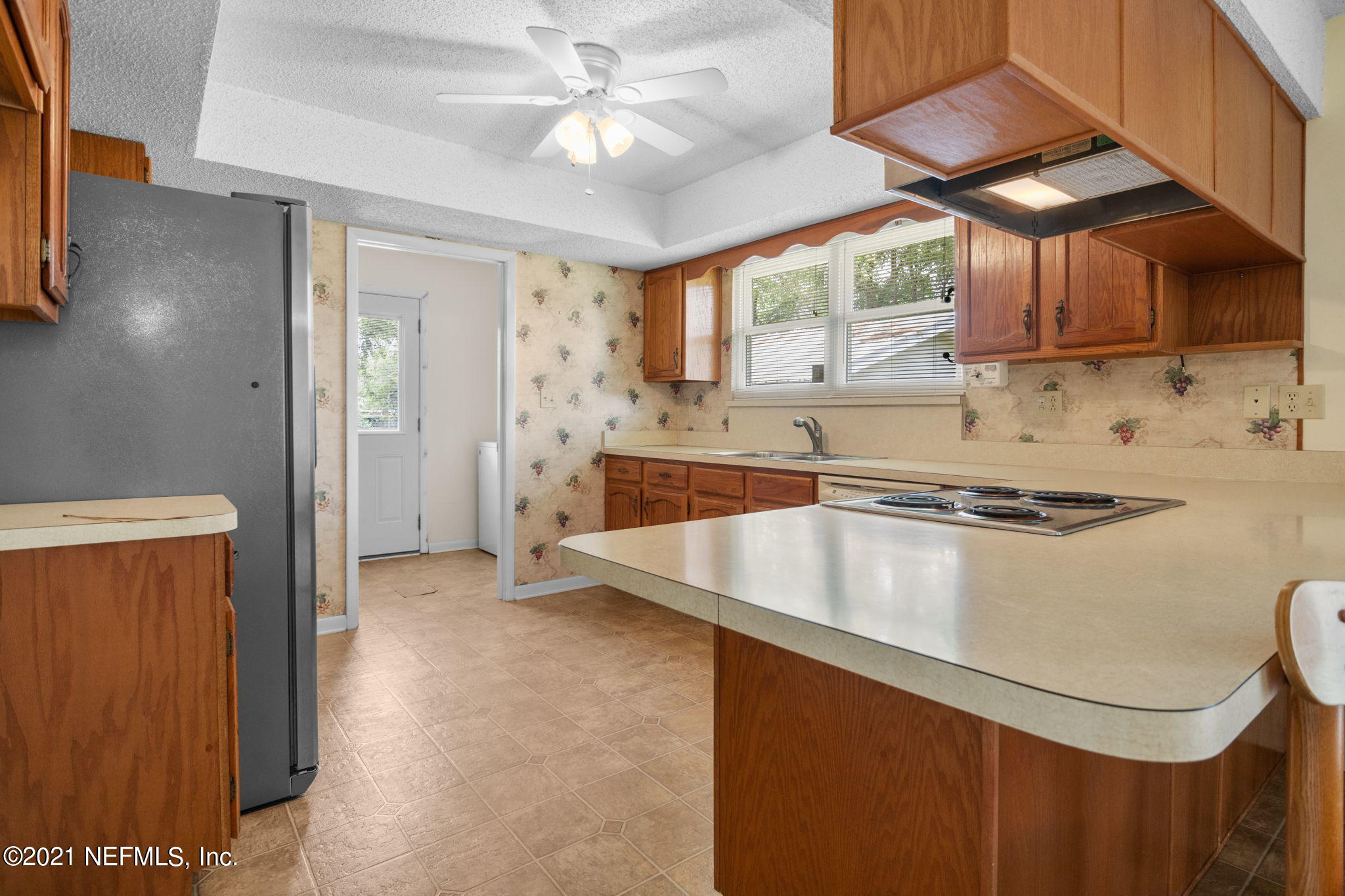 4730 Ricker Road Jacksonville, FL 32210 - Photo 10 of 30 a kitchen with stainless steel appliances granite countertop a sink a stove and a refrigerator