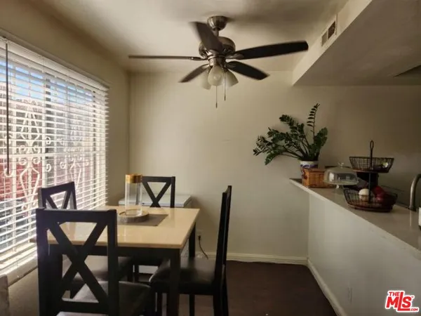 a view of a dining room with furniture and a potted plant
