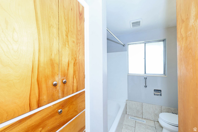 1272 Cook Street Ogden, UT 84404 - Photo 25 of 58 Bathroom featuring a white bathtub, frosted window, and light-toned floor tiling