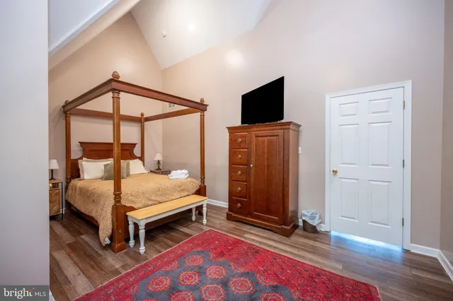 a bedroom with a bed and flat screen tv