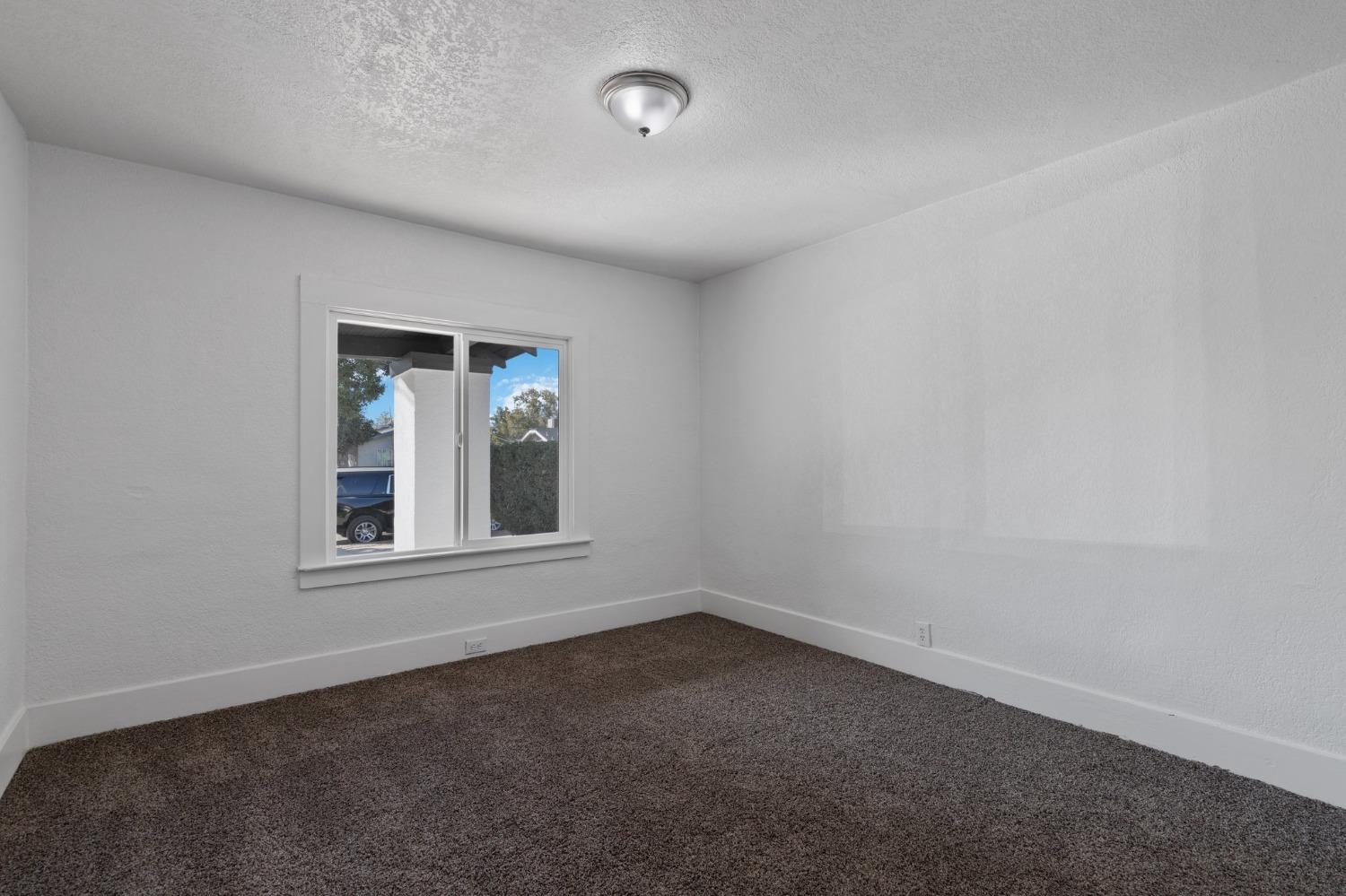 3321 East Montecito Avenue Fresno, CA 93702 - Photo 11 of 22 an empty room with a window