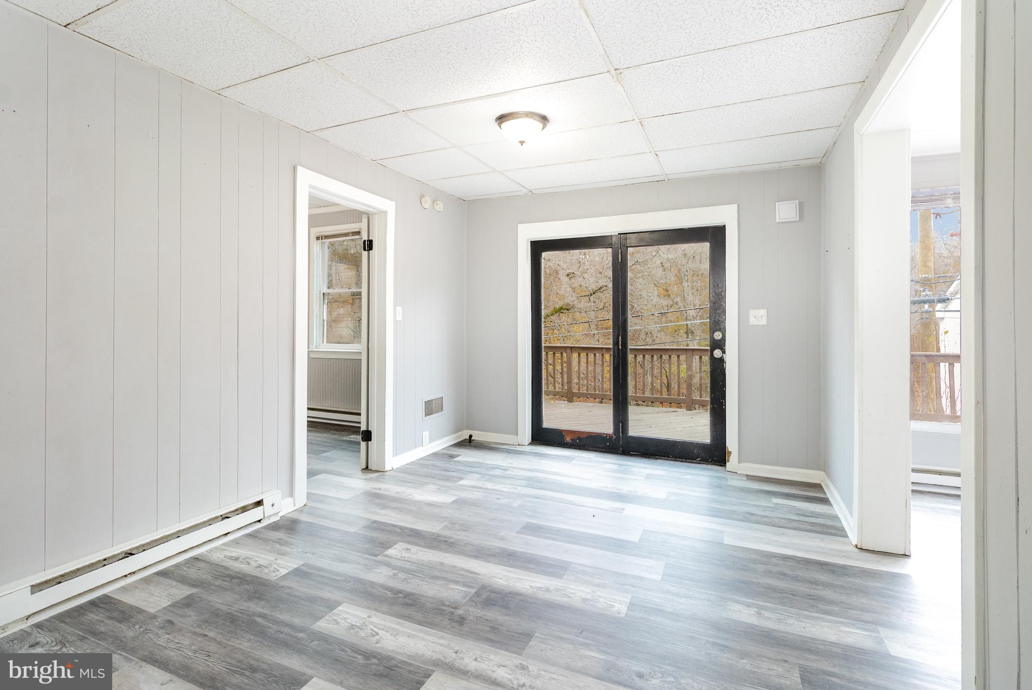650 Mohn Street Harrisburg, PA 17113 - Photo 4 of 29 an empty room with wooden floor and windows