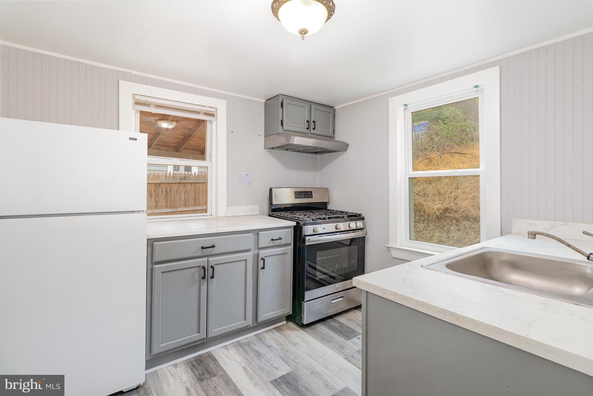 650 Mohn Street Harrisburg, PA 17113 - Photo 8 of 29 a kitchen with stainless steel appliances granite countertop a sink stove and refrigerator