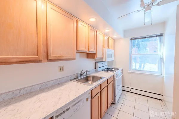a kitchen that has a sink and a stove in it