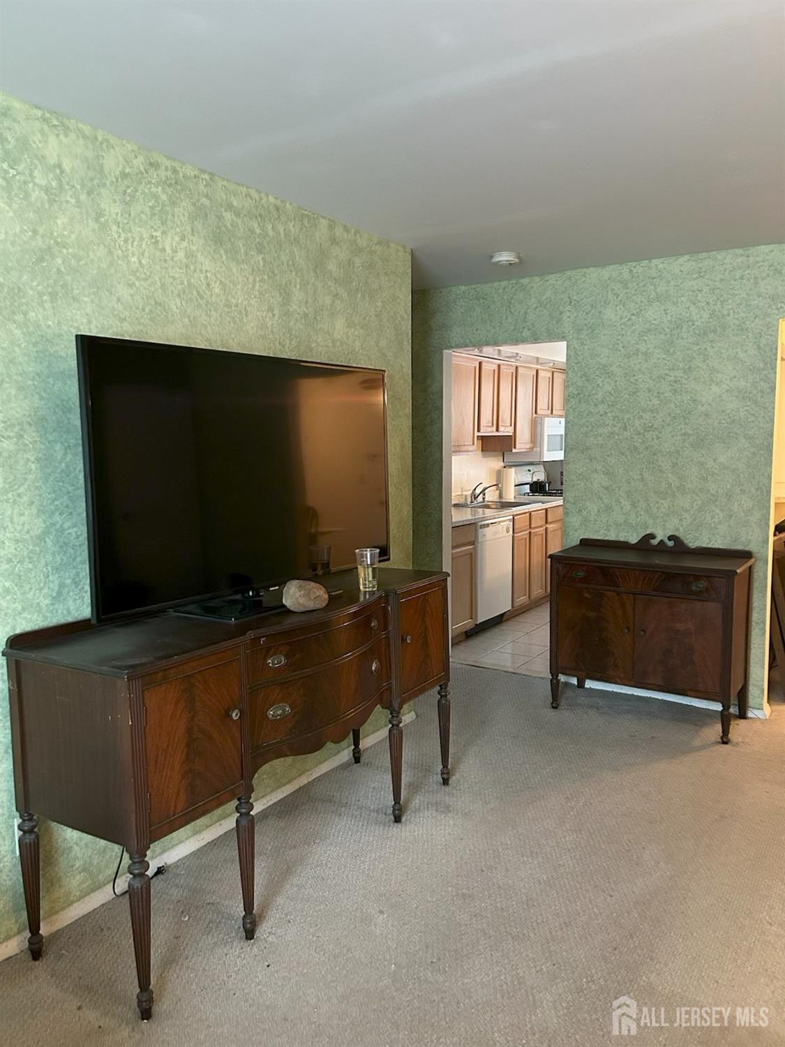 6 York Drive, Unit 5A Edison, NJ 08817 - Photo 4 of 18 a living room with furniture and a flat screen tv