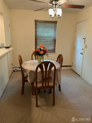 a view of a dining room with furniture and a chandelier