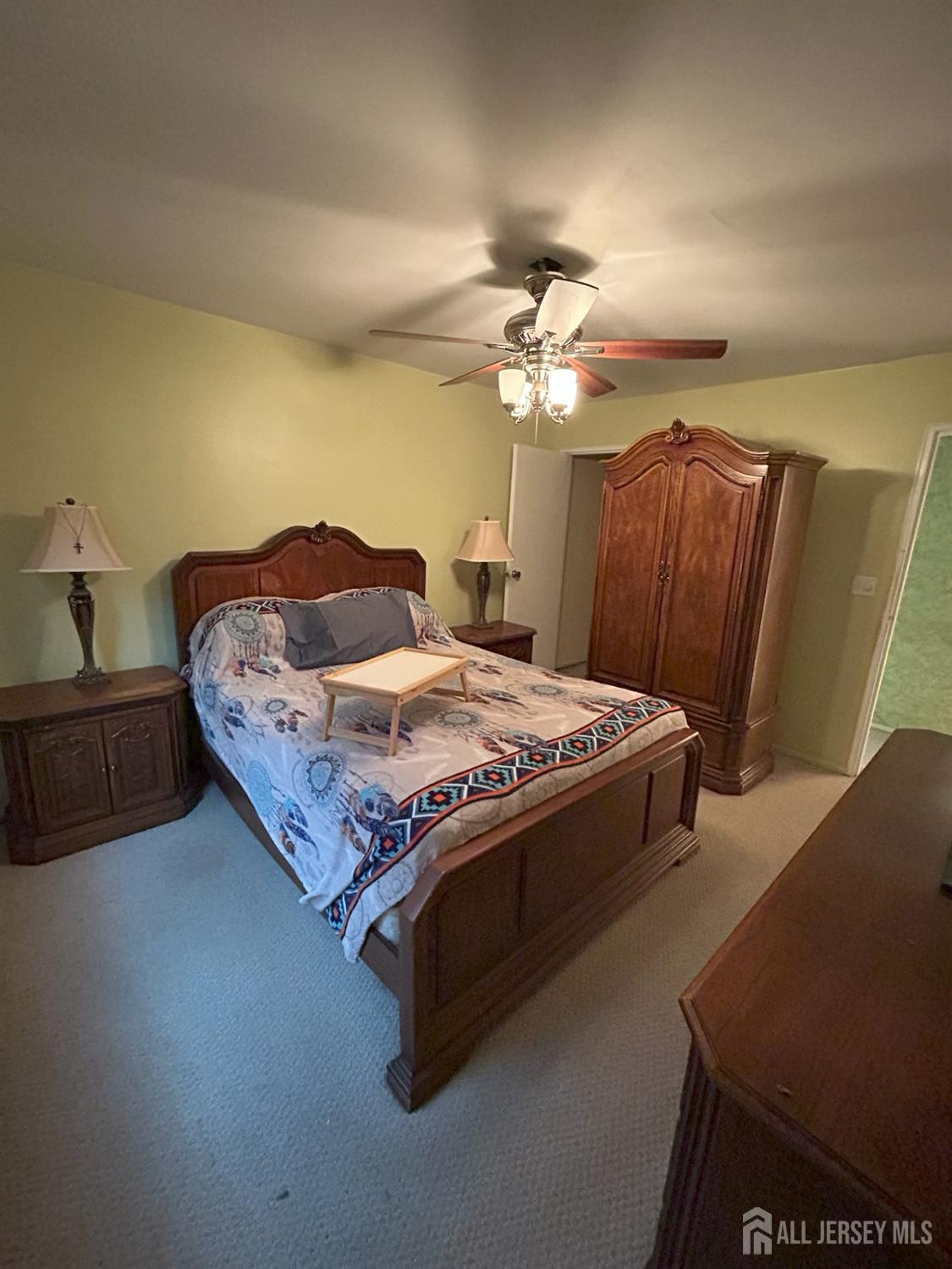 6 York Drive, Unit 5A Edison, NJ 08817 - Photo 7 of 18 a bedroom with a bed and a chandelier
