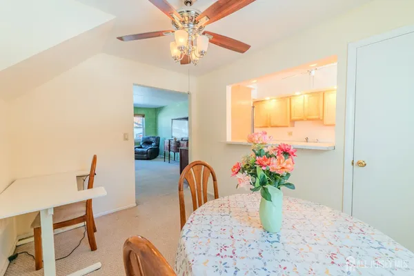 a view of a dining room with furniture and a chandelier