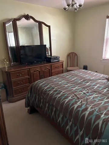 a bedroom with a bed and flat screen tv