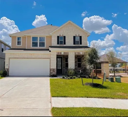 a front view of a house with a yard and porch
