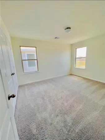 an empty room with a cabinet and a window