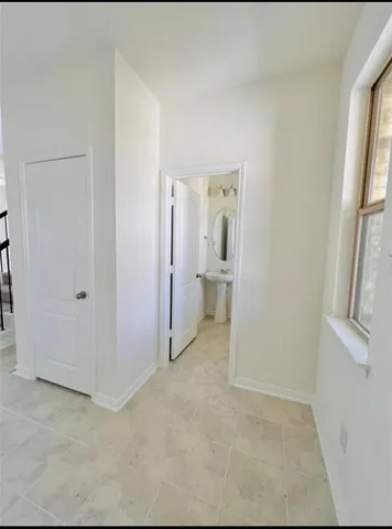 a view of a bathroom with a sink and a mirror