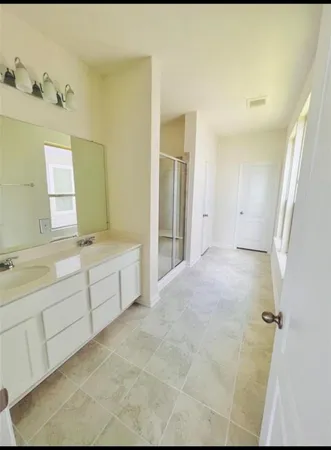 a bathroom with a tub sink and mirror