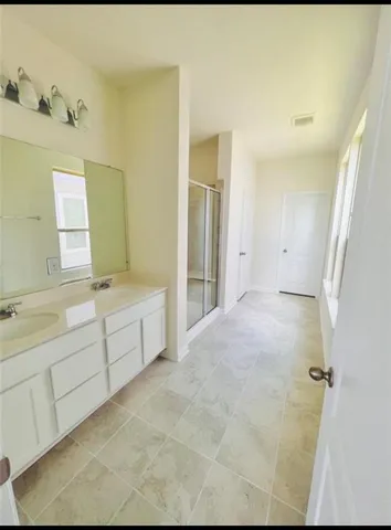 a bathroom with a tub sink and mirror