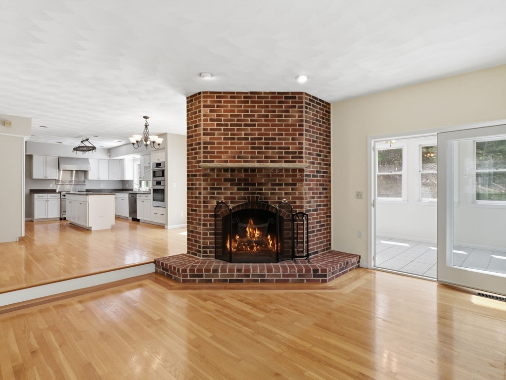 10 Hawk Ridge Road Andover, MA 01810 - Photo 11 of 32 a living room with stainless steel appliances furniture a fireplace and wooden floor