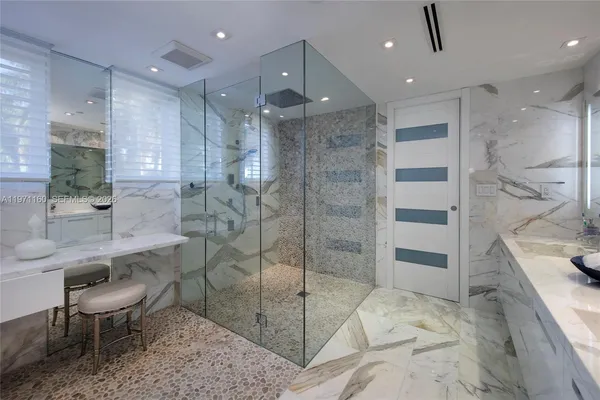 a bathroom with a double vanity sink mirror and shower