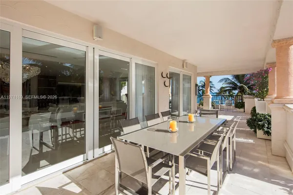 a view of a dining room with furniture and front door