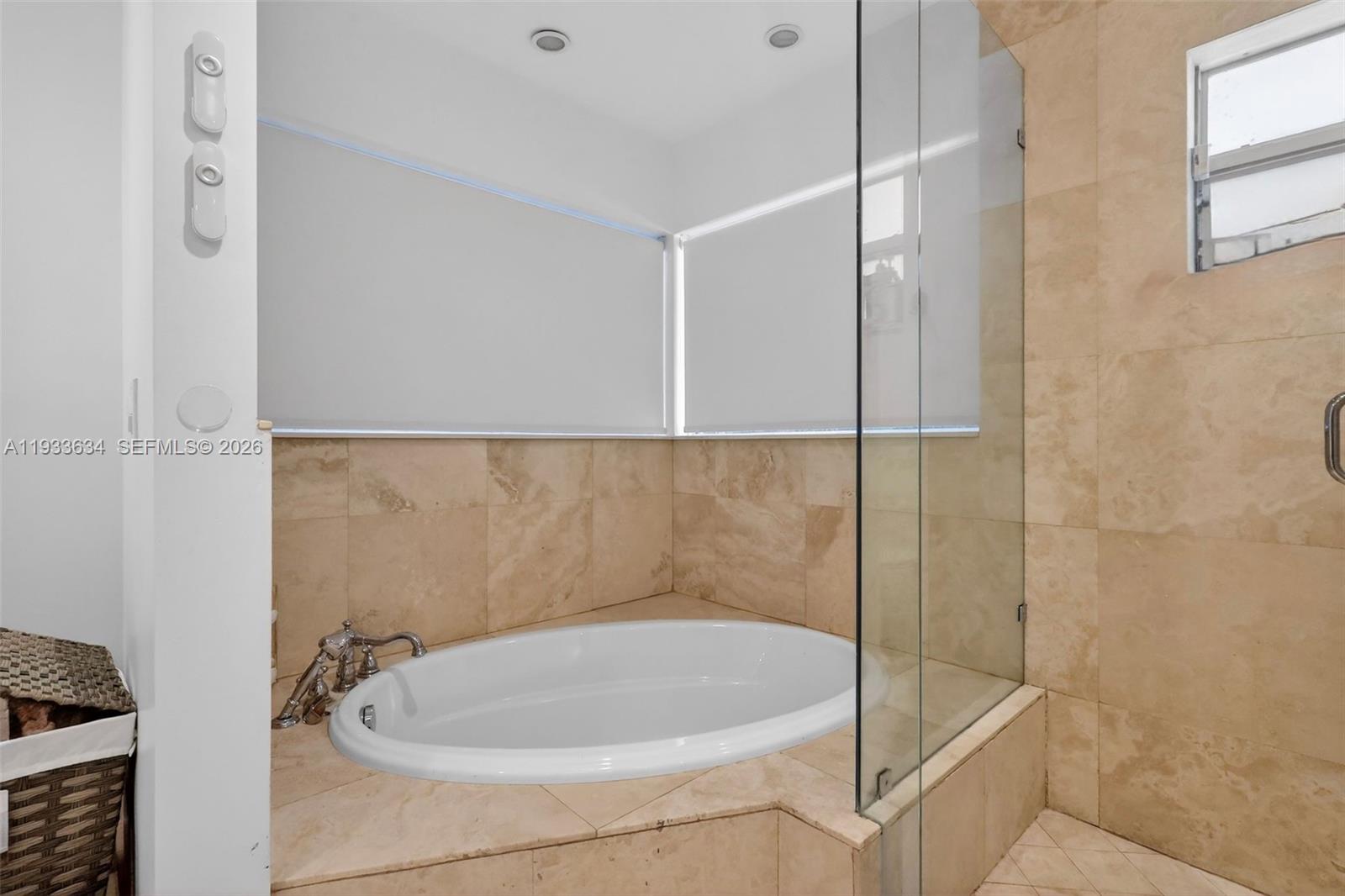 11890 Southwest 72nd Place Pinecrest, FL 33156 - Photo 22 of 39 a bathroom with a bathtub