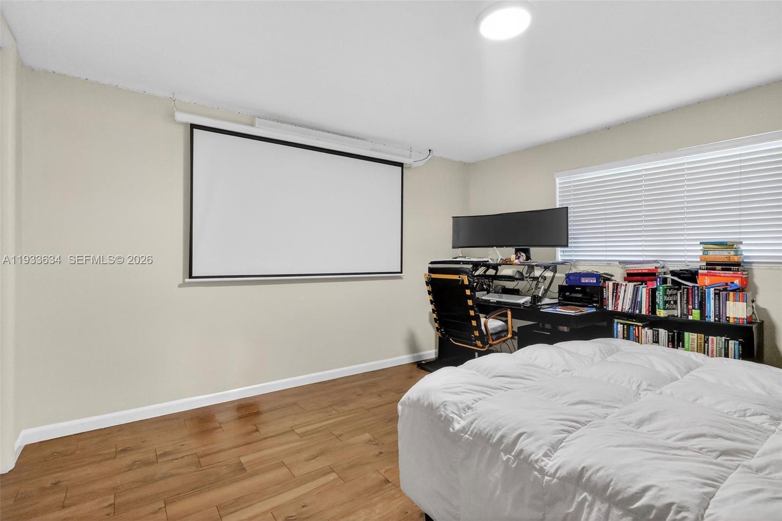 11890 Southwest 72nd Place Pinecrest, FL 33156 - Photo 26 of 39 a bed room with a bed and a television