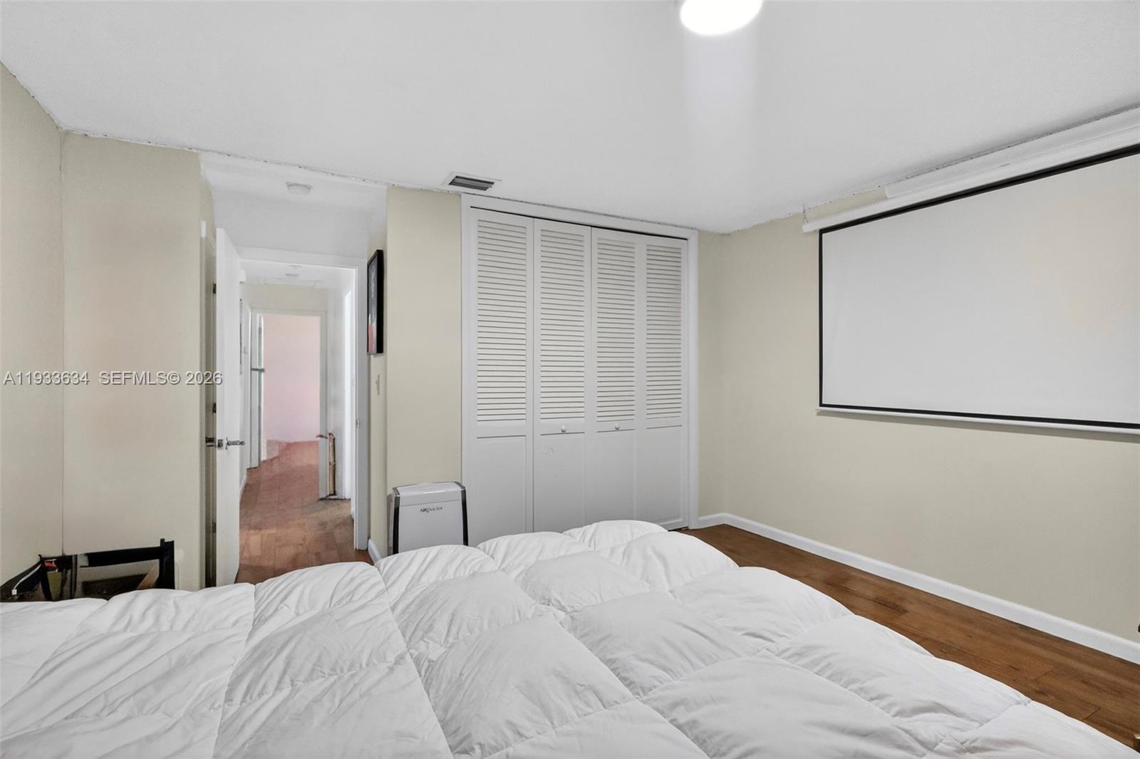 11890 Southwest 72nd Place Pinecrest, FL 33156 - Photo 27 of 39 a bedroom with a bed and a window