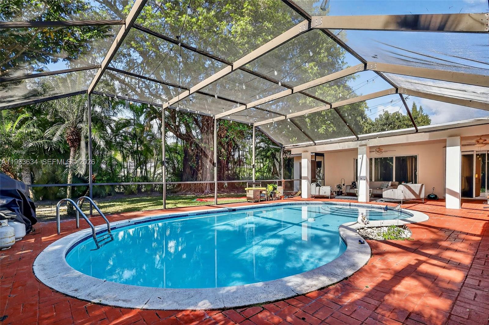 11890 Southwest 72nd Place Pinecrest, FL 33156 - Photo 36 of 39 a view of a backyard with swimming pool
