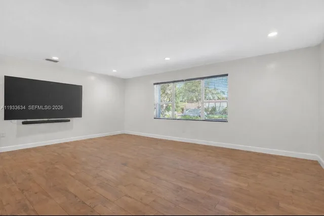 a view of an empty room with a flat screen tv
