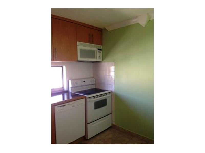 17021 North Bay Road, Unit 910 Sunny Isles Beach, FL 33160 - Photo 11 of 19 a kitchen with a stove and a microwave
