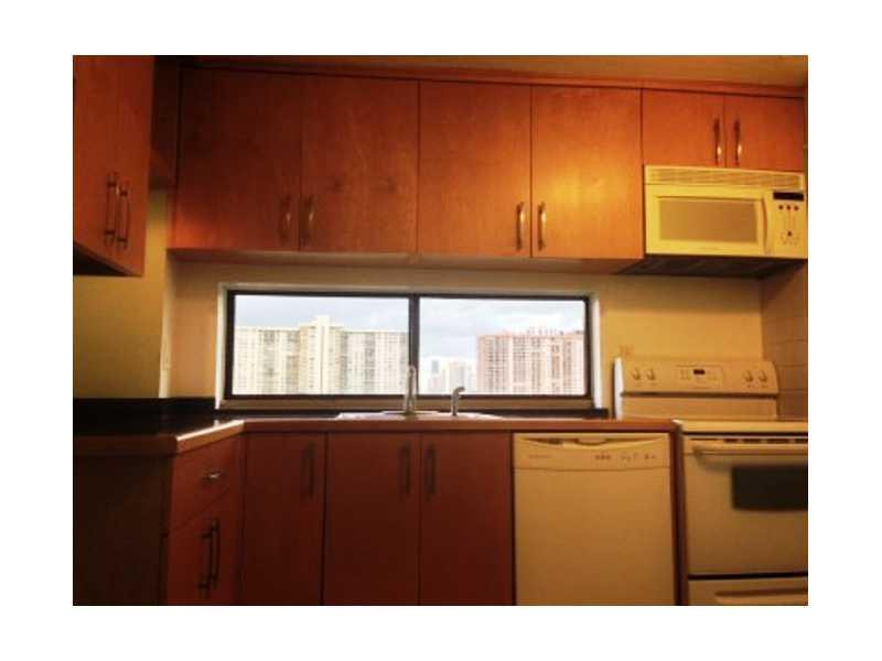 17021 North Bay Road, Unit 910 Sunny Isles Beach, FL 33160 - Photo 9 of 19 a kitchen with a sink a window and cabinets