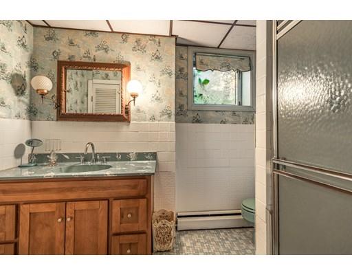 22 Bishops Lane Lynnfield, MA 01940 - Photo 13 of 31 a bathroom with a granite countertop sink a mirror and a shower