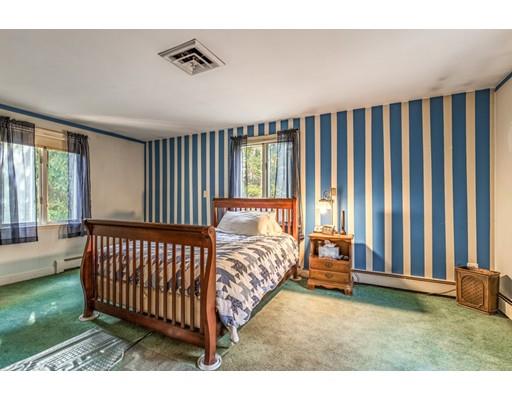 22 Bishops Lane Lynnfield, MA 01940 - Photo 15 of 31 a bed sitting in a bedroom next to a window