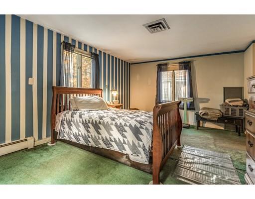 22 Bishops Lane Lynnfield, MA 01940 - Photo 16 of 31 a spacious bedroom with a bed and large windows