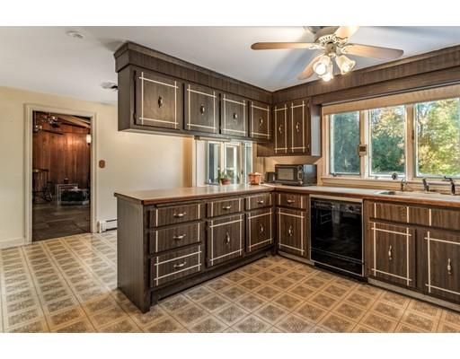 22 Bishops Lane Lynnfield, MA 01940 - Photo 6 of 31 a kitchen with stainless steel appliances granite countertop a stove a sink dishwasher and a microwave oven