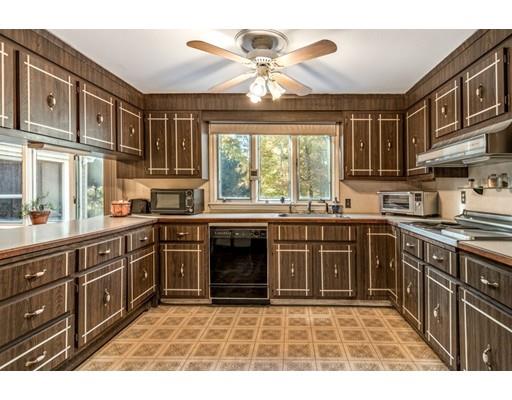 22 Bishops Lane Lynnfield, MA 01940 - Photo 7 of 31 a kitchen with stainless steel appliances granite countertop a stove sink and cabinets
