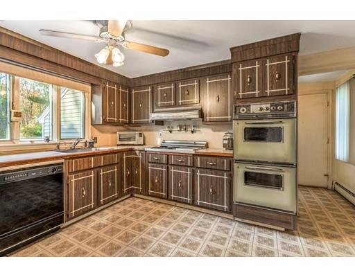22 Bishops Lane Lynnfield, MA 01940 - Photo 8 of 31 a kitchen with a stove a sink and a microwave