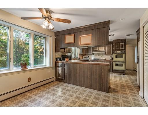 22 Bishops Lane Lynnfield, MA 01940 - Photo 10 of 31 a kitchen with kitchen island a large counter top space appliances and a center island