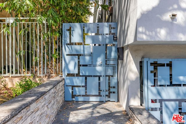 a kitchen with stainless steel appliances a refrigerator and a wooden floor