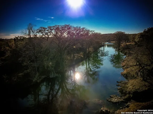 a view of a lake in middle of forest