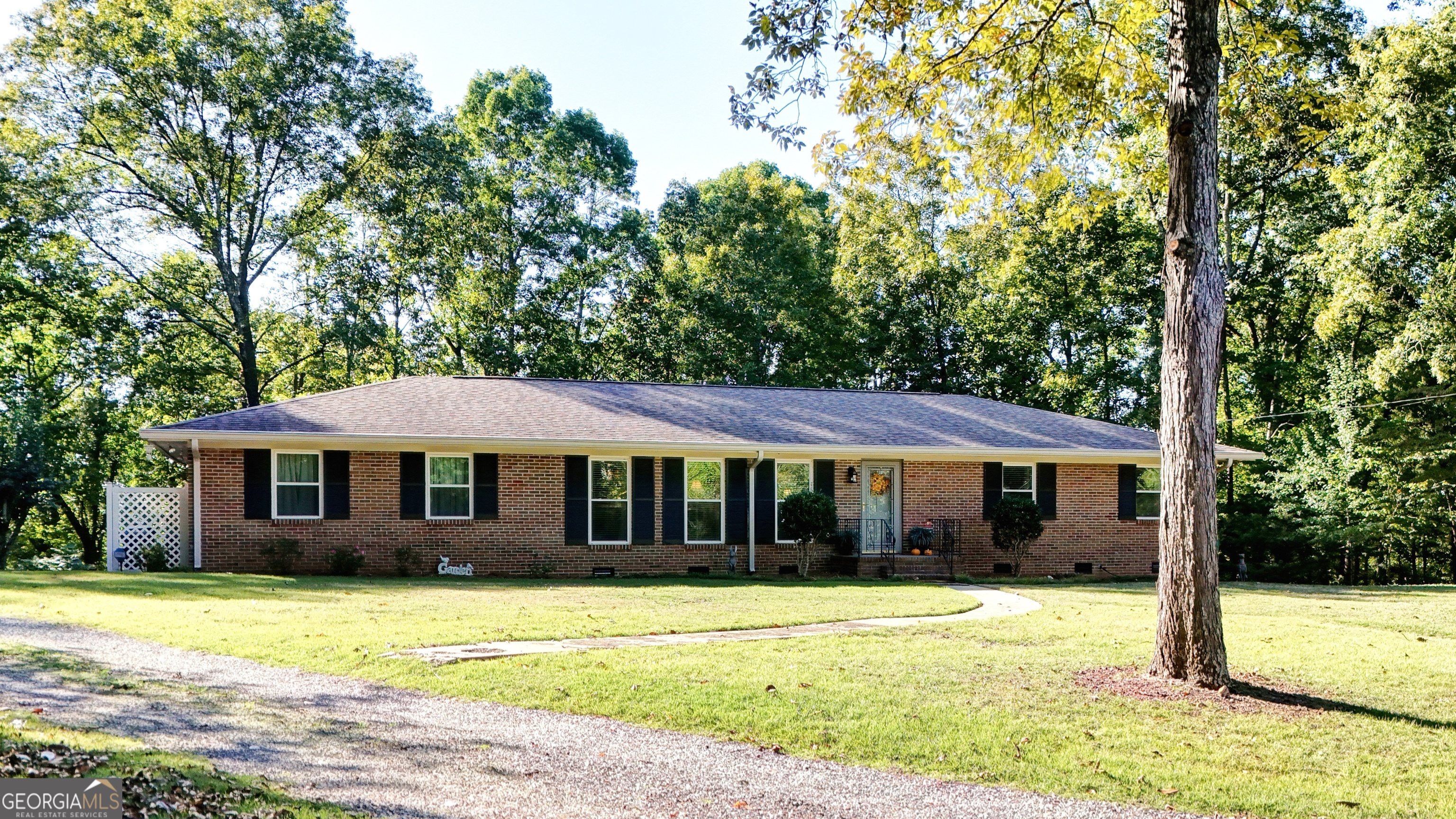 a front view of a house with a garden