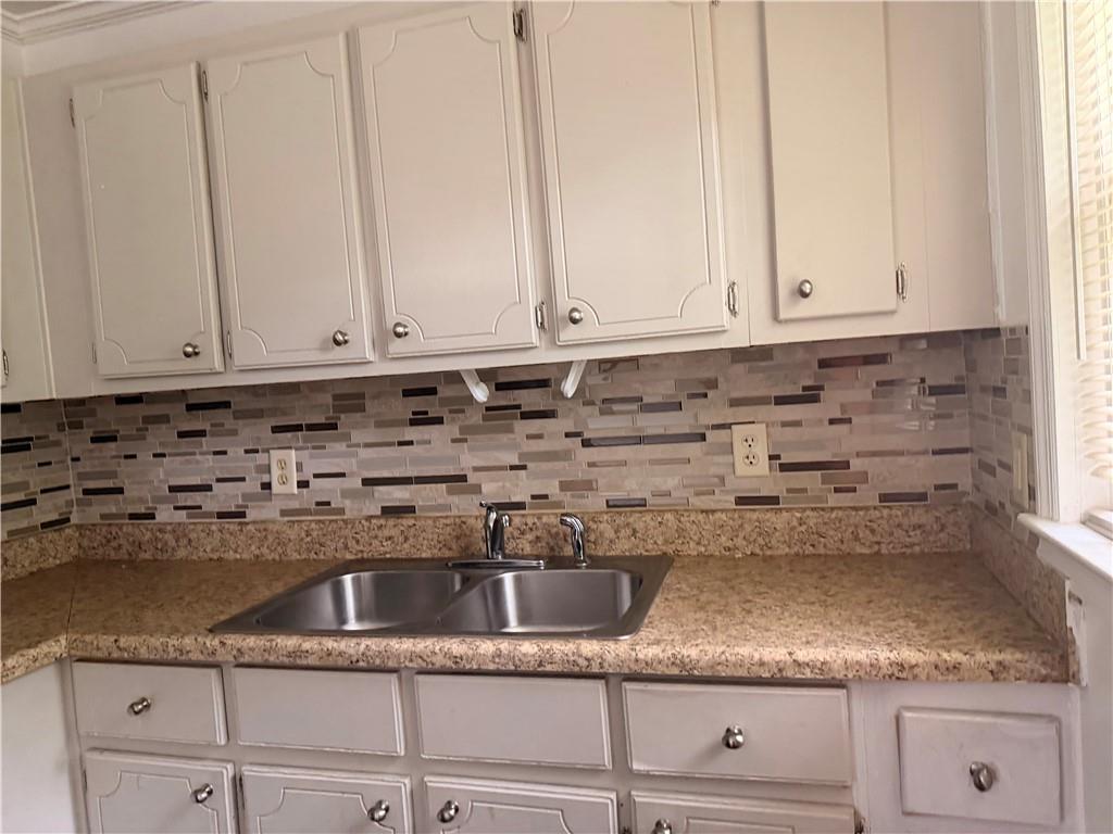 3151 Bluebird Lane Decatur, GA 30032 - Photo 8 of 16 a kitchen with granite countertop white cabinets and a sink