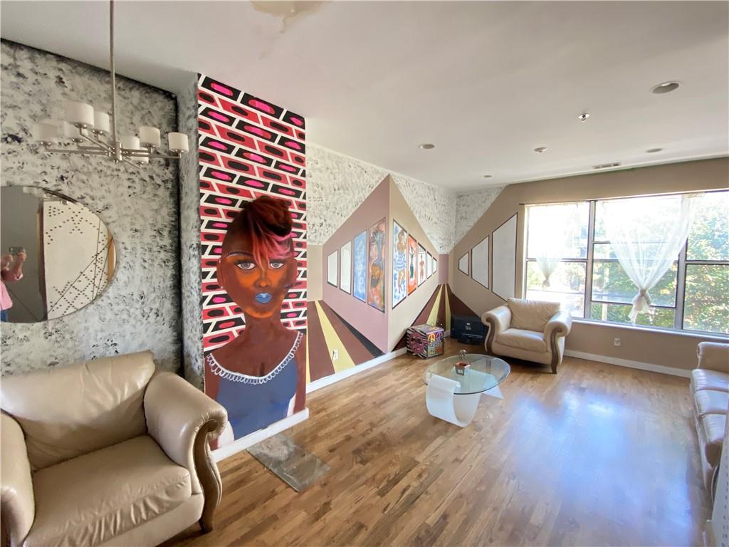 a living room with furniture and wooden floor