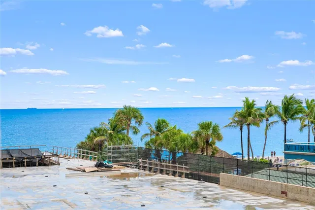a kitchen with kitchen island granite countertop wooden floor cabinets and appliances