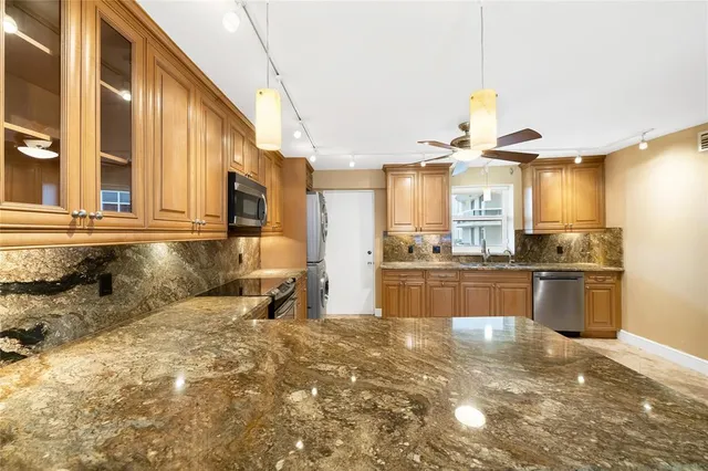 a view of kitchen with furniture and windows