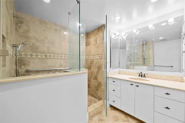 a bathroom with a granite countertop shower mirror and a sink